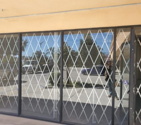 A glass door featuring a diamond pattern, allowing light to pass through while providing a decorative element.